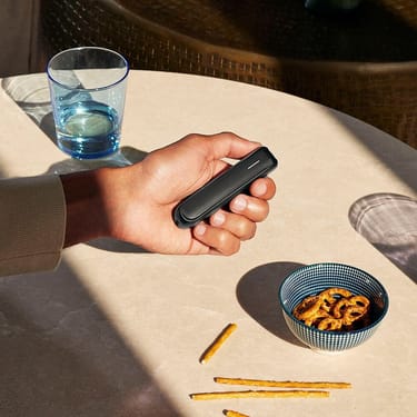 Ploom AURA front panel Jet Black accessory attached to device.