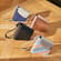 Hand taking a Ploom AURA device out of the Ploom Duo Carry Case Rose Gold
